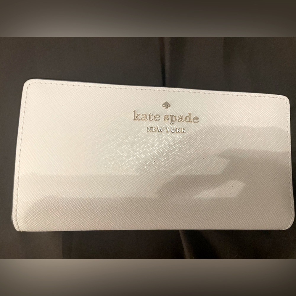 White Kate Spade wallet with brown trim
